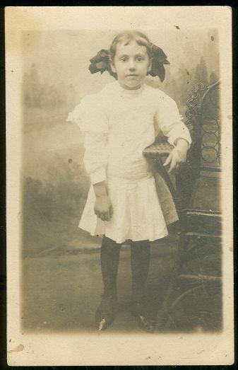Image for REAL PHOTO POSTCARD OF LITTLE GIRL IN WHITE WITH BIG BOW
