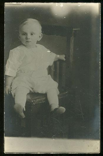 Image for REAL PHOTO POSTCARD OF BABY BOY SITTING IN CHAIR