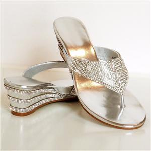 Low heel silver wedge sandals Ladies’ wedge sandals are distinct in that they come with a slight graduated heel. Wedges offer a pleasant compromise between a high heel and a flat, marrying some of the height of the former with some of the stability of the latter.
