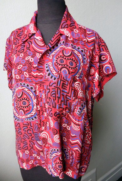 This cool Tiki print silky rayon Hawaiian shirt has the Campus label and