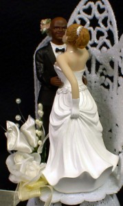 Black groom and white bride wedding cake toppers