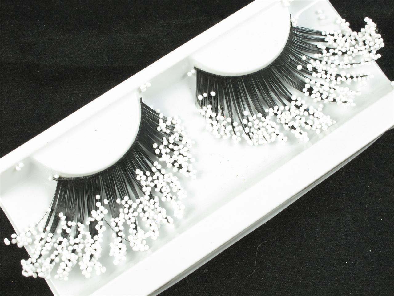 EXAGGERATE LONG AT SIDES WITH WHITE BEADS IN 2 END BLACK FAKE FALSE