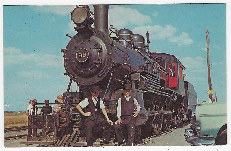 Postcard - Two Amish Boys Resting on the Old 98, Strasburg Rail Road, Strasburg, Pennsylvania