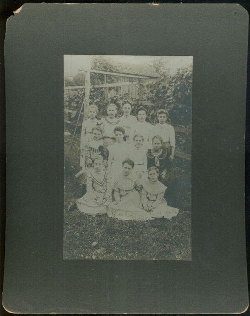 Image for FRAMED PHOTOGRAPH OF GROUP OF YOUNG GIRLS AND TEACHER POSING OUTSIDE