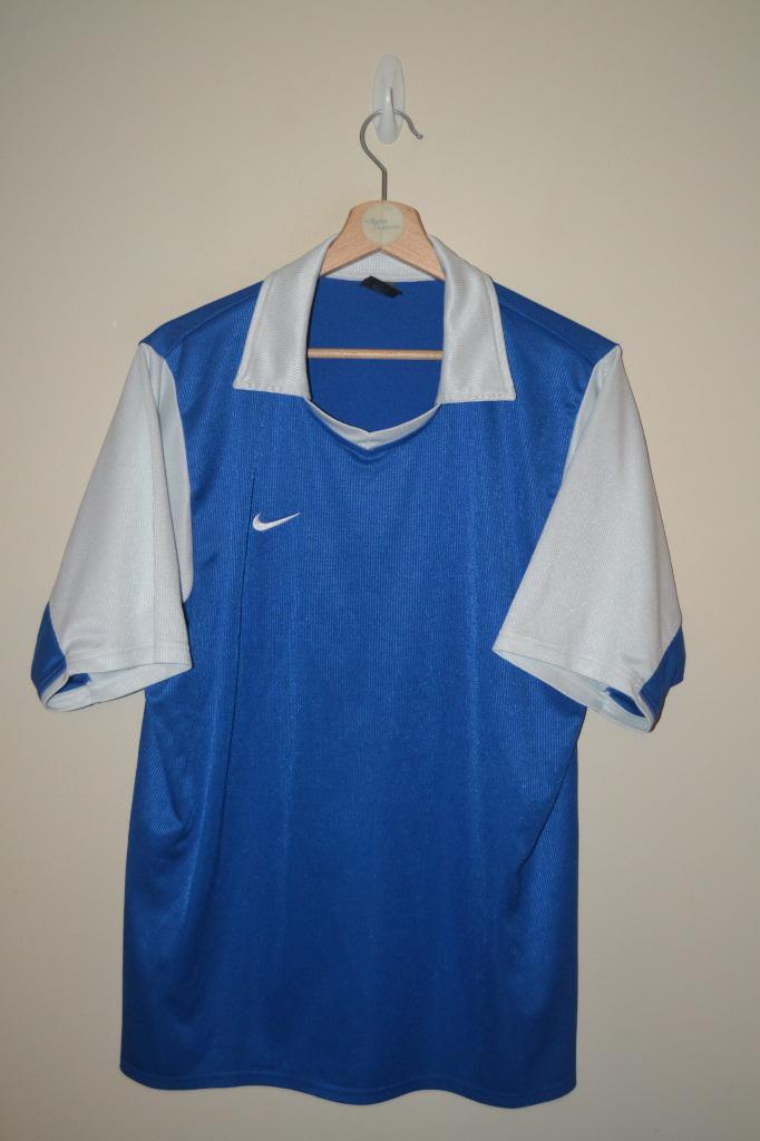 white nike shirt with blue swoosh